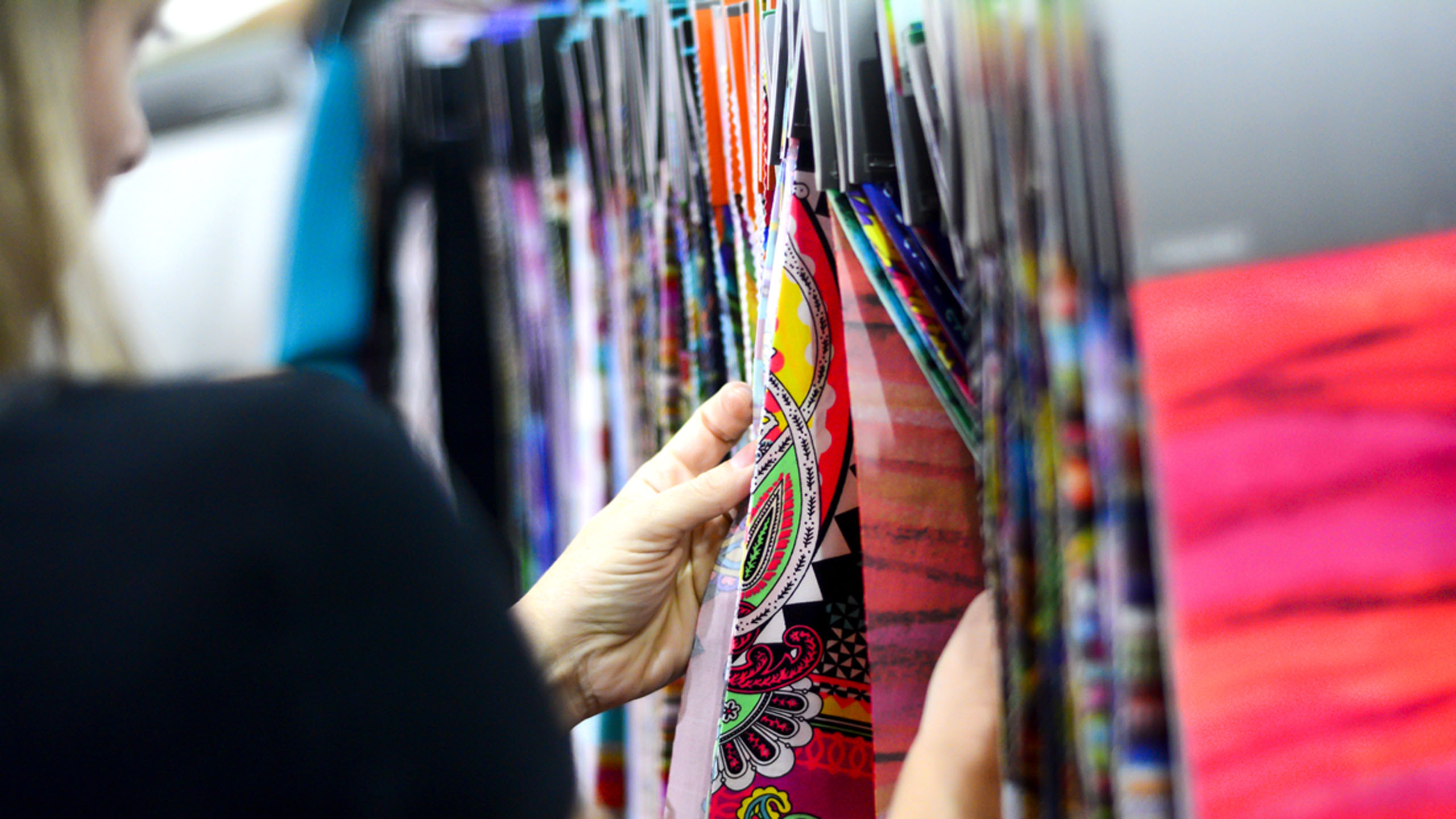 emitex visitor looking at fabrics